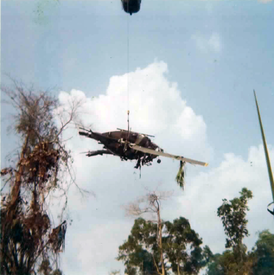 The crashed Huey being lifted from the jungle by a Sikorsky Sky Crane